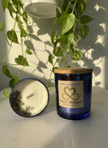 Honey Lavender Haze scented candle in blue glass jar with wooden lid, home fragrance decor